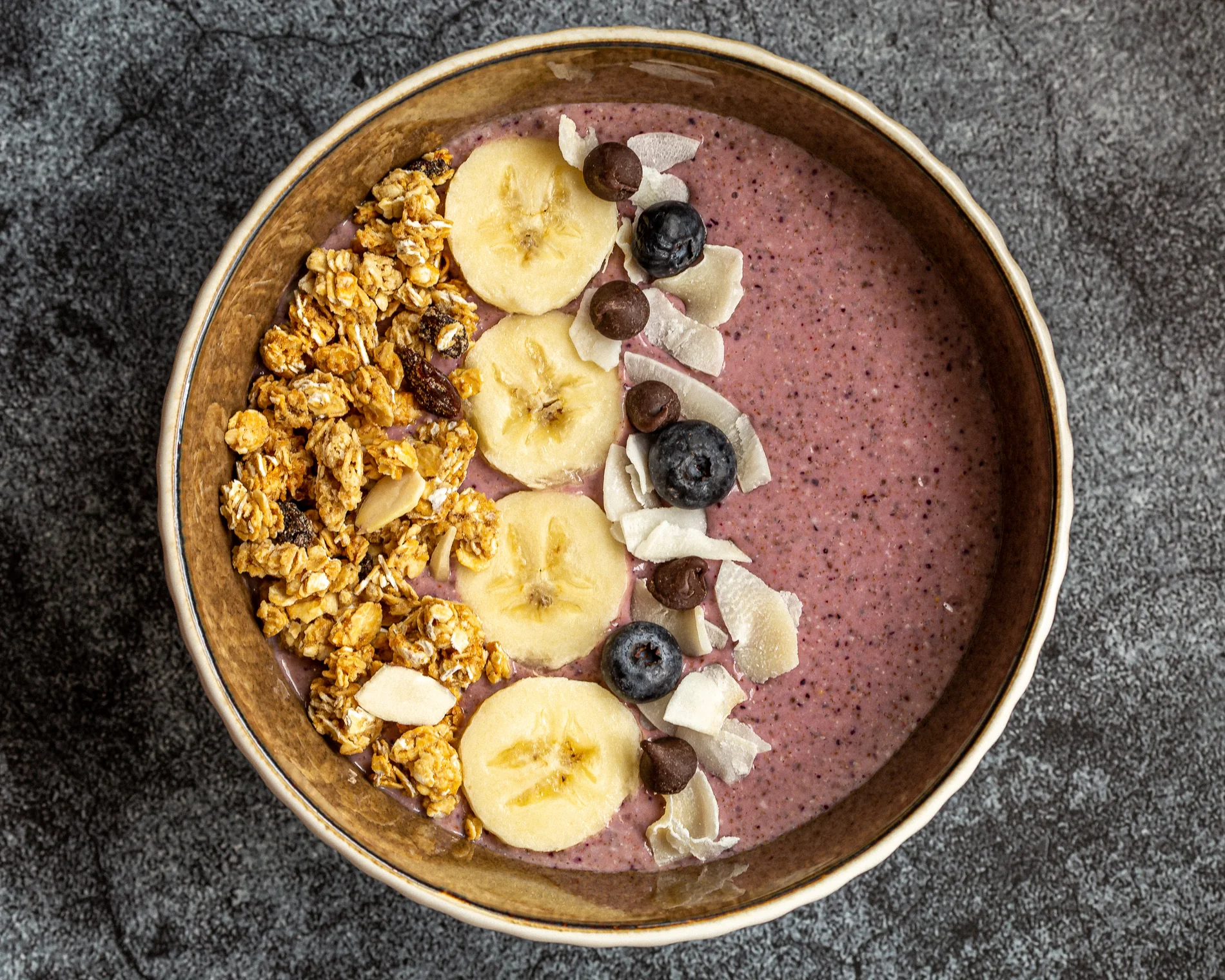 Açaí bowl with fruit and granola, photographed from above