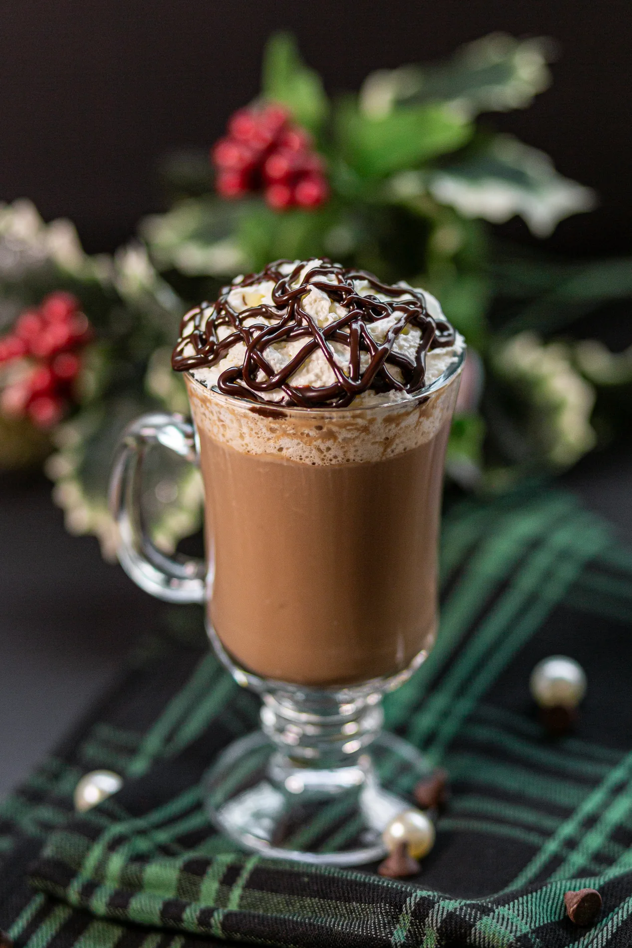 Festive hot cocoa in a glass with whipped cream