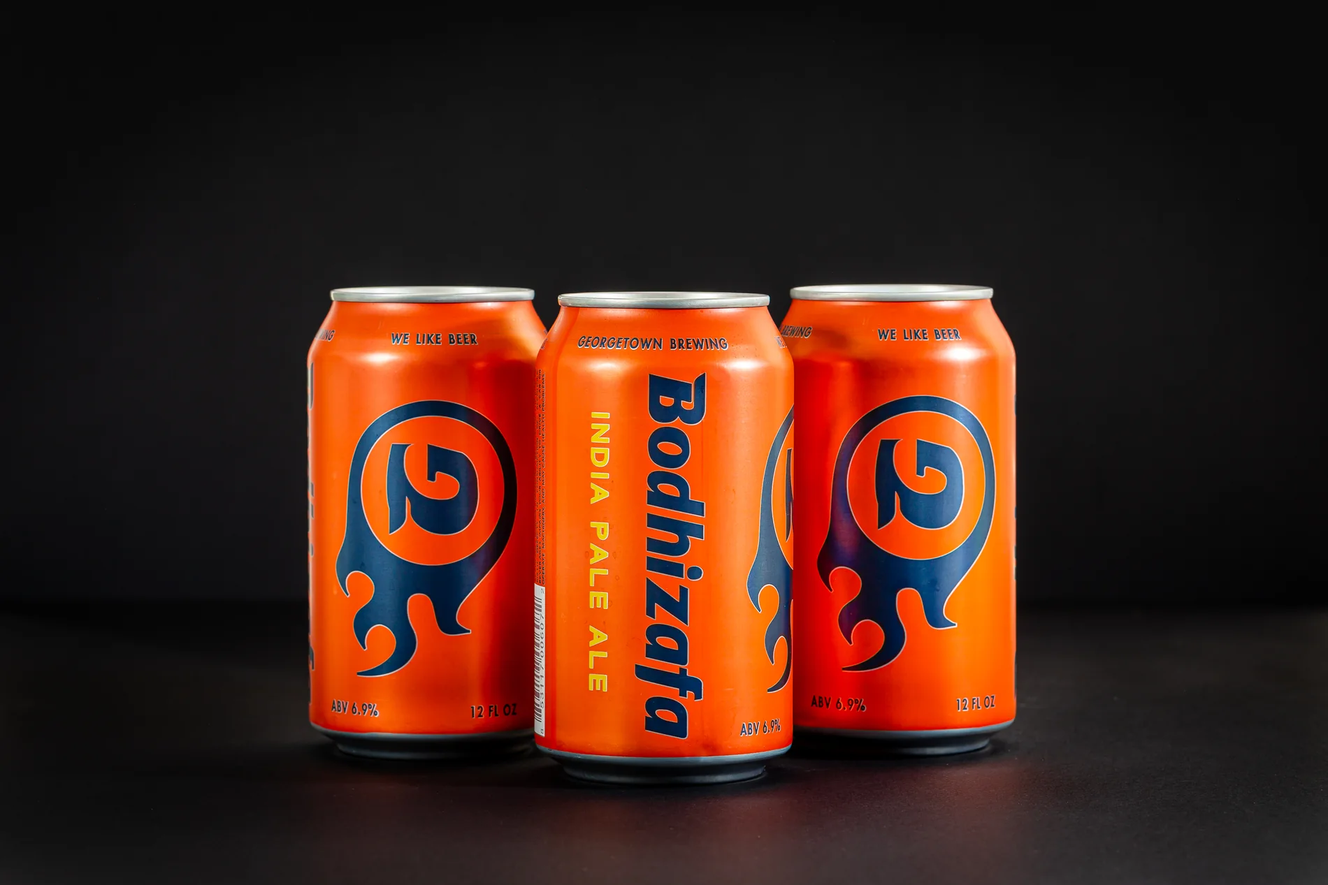 Three Bodhizafa IPA cans in a dark studio setup