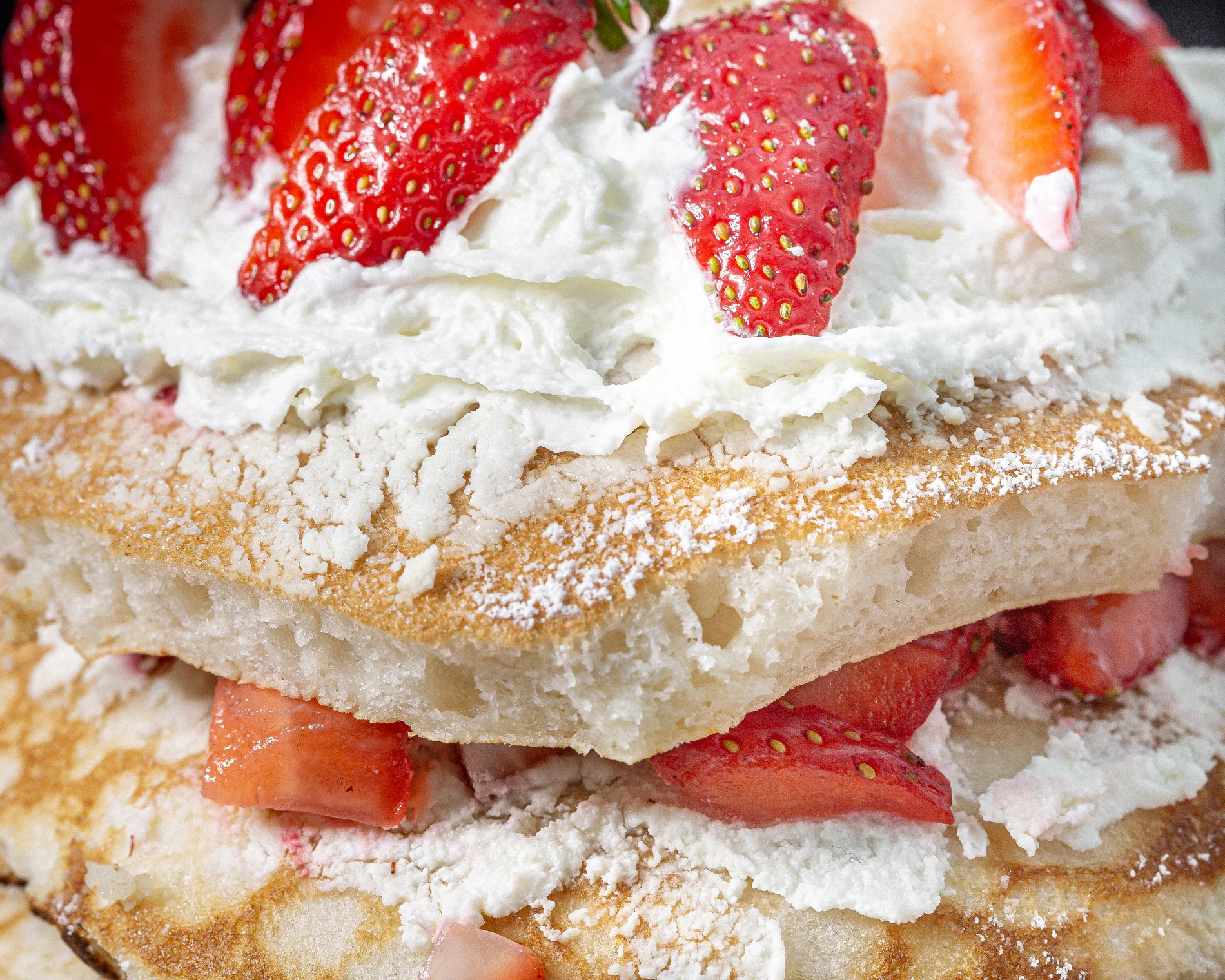 Turmeric & Pepper strawberry pancakes with fruit and cream